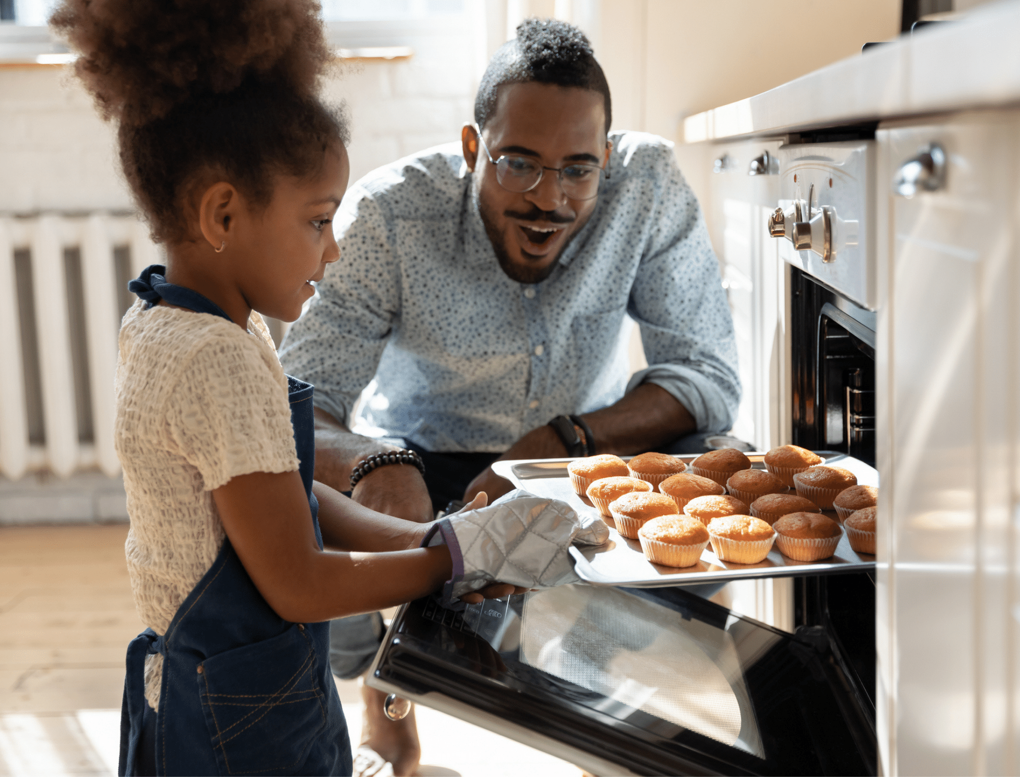 Young Black girl cooks with her father. Explore children's activities for Black History Month with Britt Hawthorne.