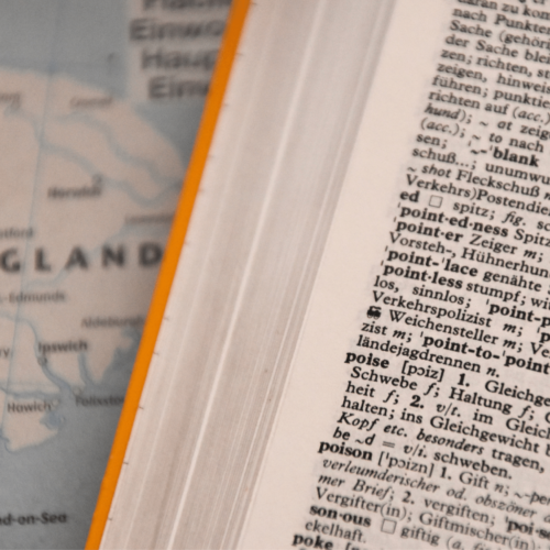 A dictionary sits on a map of England. Learn alternatives for racist idioms with Britt Hawthorne.
