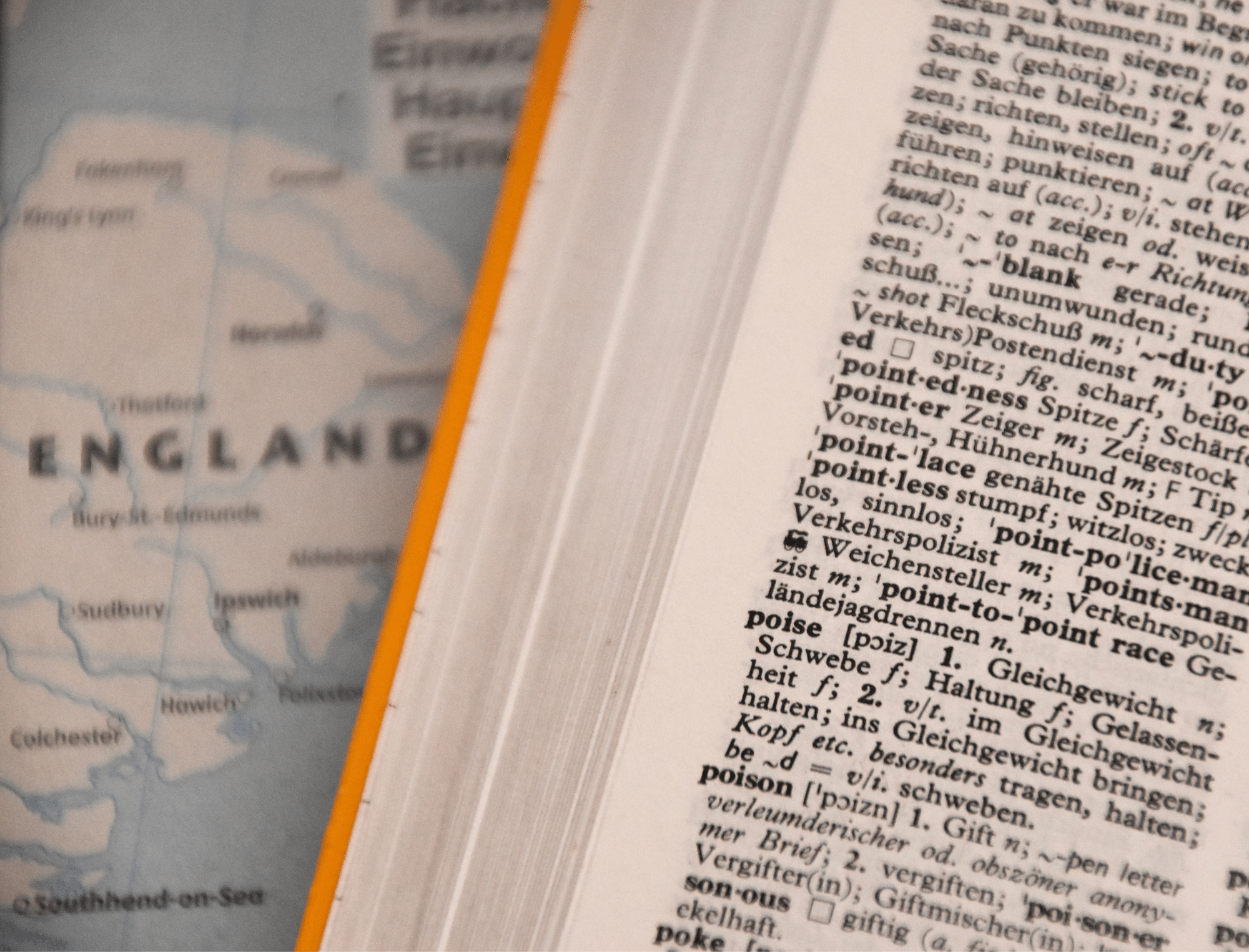 A dictionary sits on a map of England. Learn alternatives for racist idioms with Britt Hawthorne.