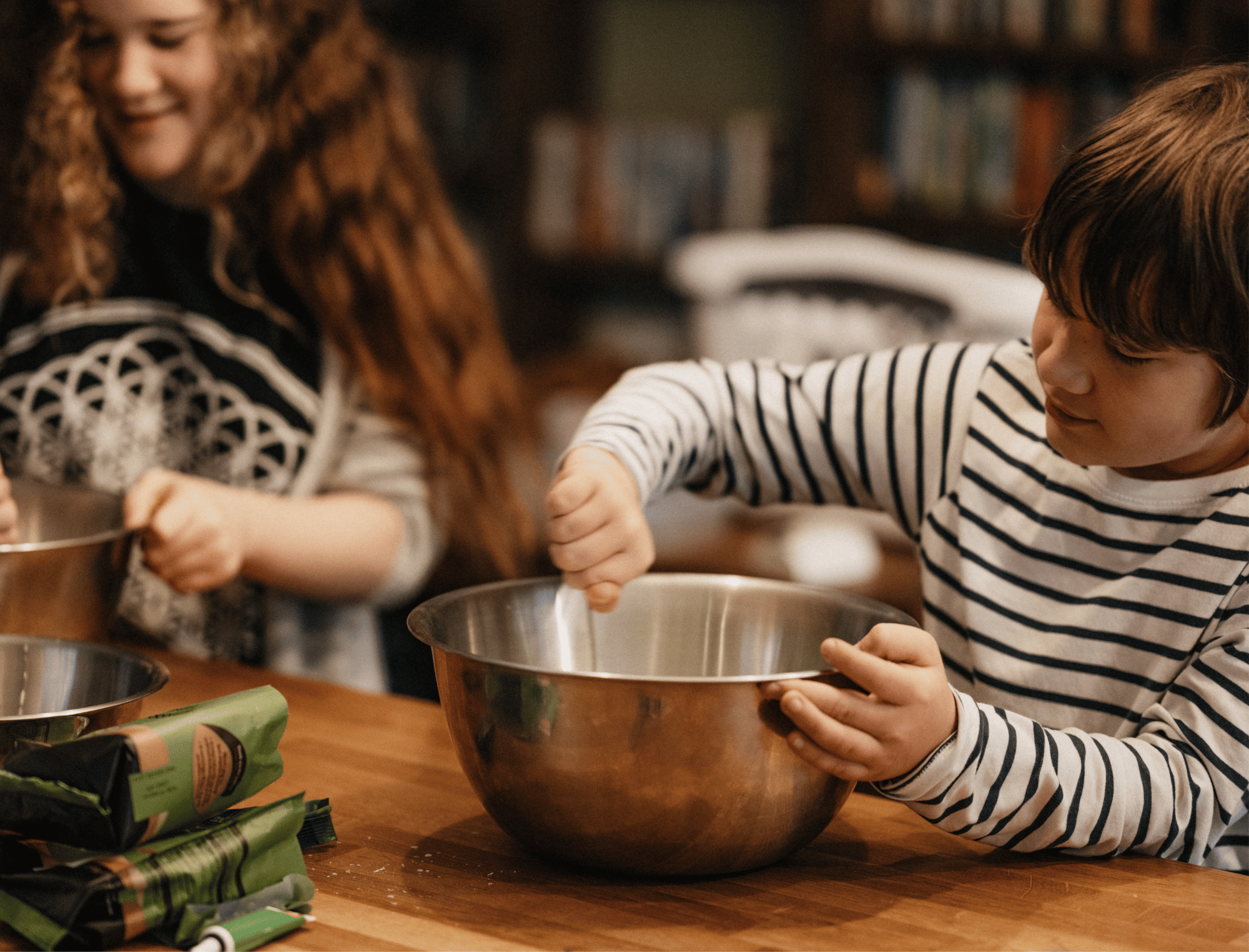 Two children cooking in a kitchen with metal bowls. Explore JAHM activities with Britt Hawthorne.