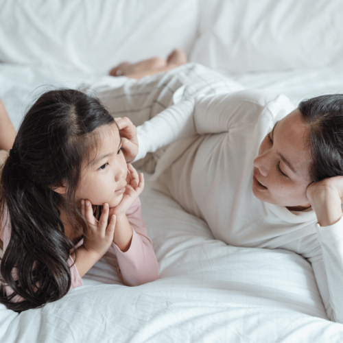 Mom and daughter talk on the bed. Explore Britt Hawthorne’s self-advocacy phrases.