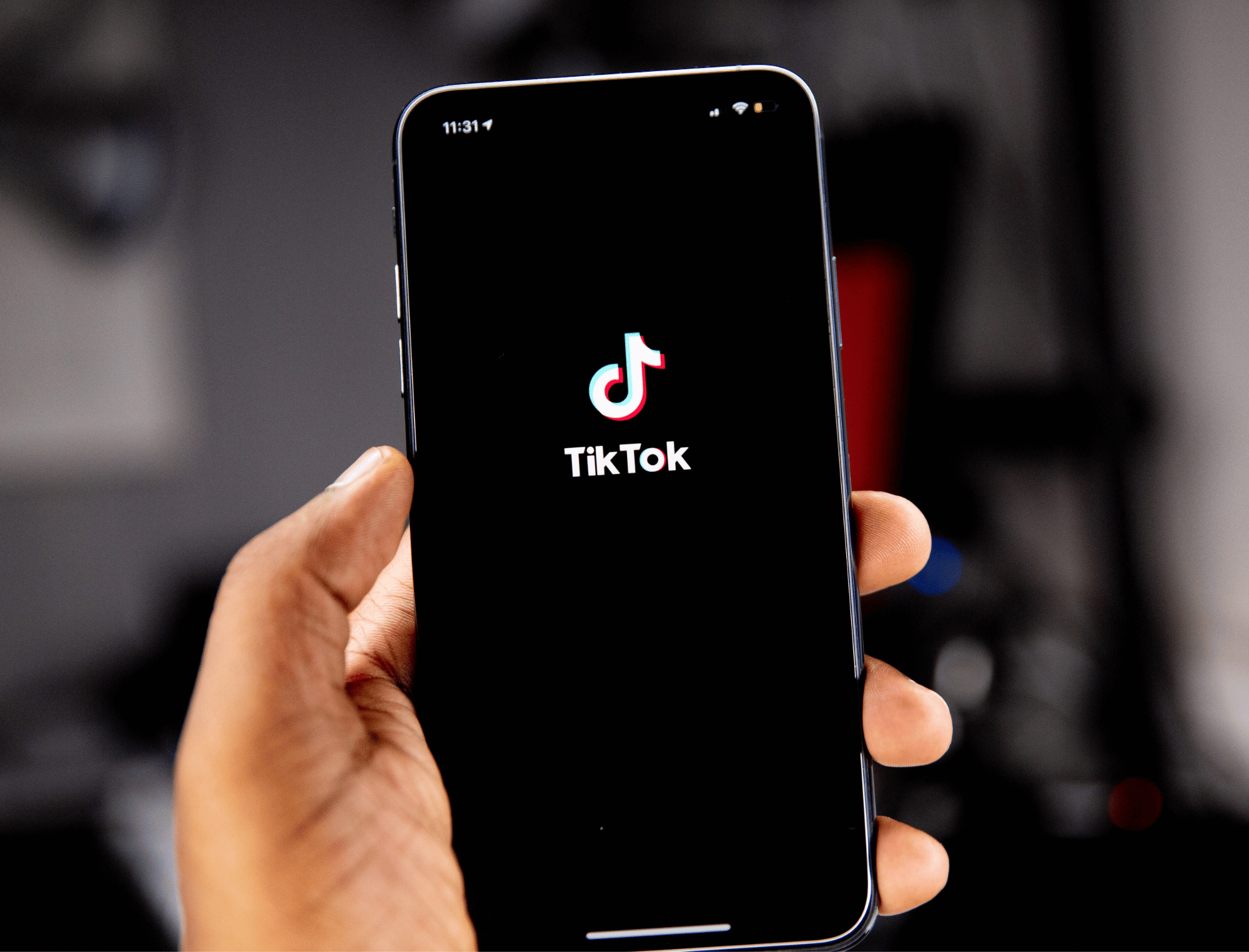 Person holding an iPhone with the TikTok app open. Discover 5 Gen Z activists with Britt Hawthorne. Photo: Solen Feyissa.